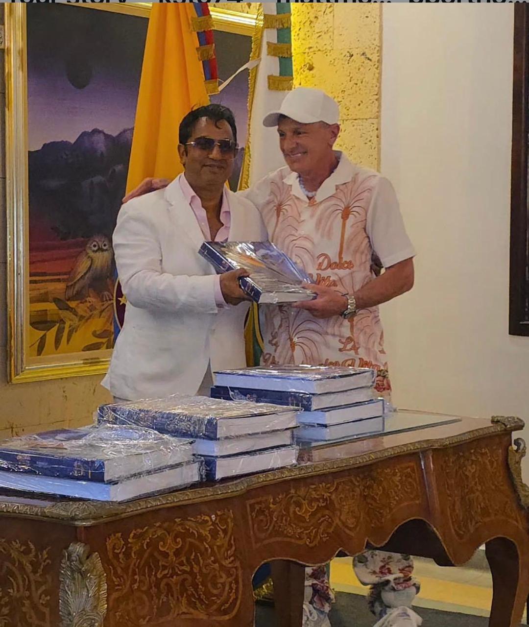 Dr Alrashid presenting a collection of art volumes to a featured artist